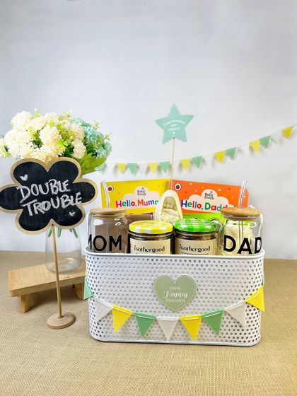 A 'Double Trouble' themed gift basket for parents of twins. The chalkboard sign and matching 'Mom' and 'Dad' jars make this a unique and thoughtful gift idea.