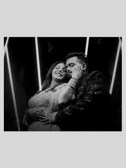 A candid black and white shot of a couple sharing a laugh. Sometimes, removing color helps focus on the raw emotion and genuine connection, creating a timeless memory.