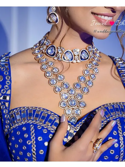 For a Sangeet or Reception, you can truly shine. This bold, layered Polki necklace with a unique design is perfect for a modern bride. The large uncut stones catch the light beautifully, making it a centerpiece for your glamorous evening look.