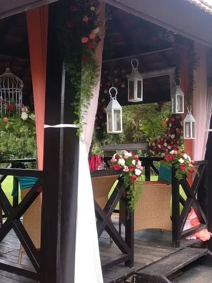 An intimate and romantic surprise birthday party in a beautiful outdoor gazebo. We used soft drapes, hanging lanterns, and floral arrangements to create a special atmosphere.