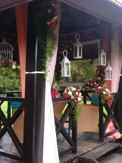 An intimate and romantic surprise birthday party in a beautiful outdoor gazebo. We used soft drapes, hanging lanterns, and floral arrangements to create a special atmosphere.