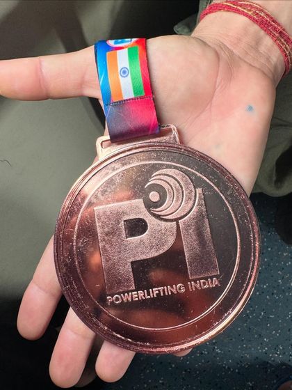A close up of the bronze medal won by my student Sonia Dhaka in her very first Junior National Powerlifting Championship, lifting a total of 432.5 kg.