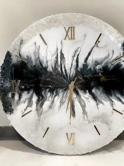 Looking for a unique statement piece for your living room? This large 24-inch resin wall clock features a dramatic black and white abstract design, perfect for modern interiors.