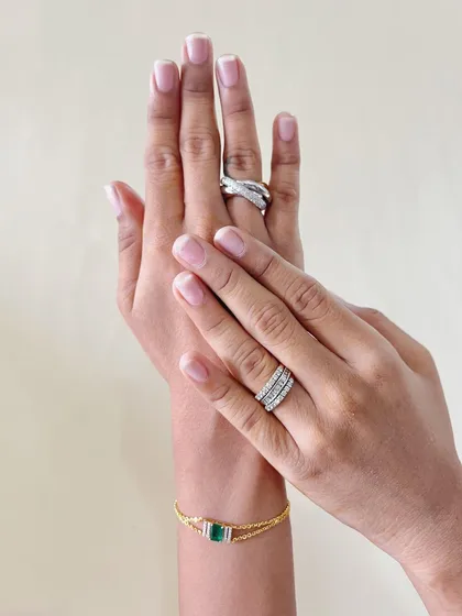 Where elegance is eternal and sparkle is endless. This image showcases a beautiful pairing of diamond rings and an emerald bracelet, a testament to timeless style.