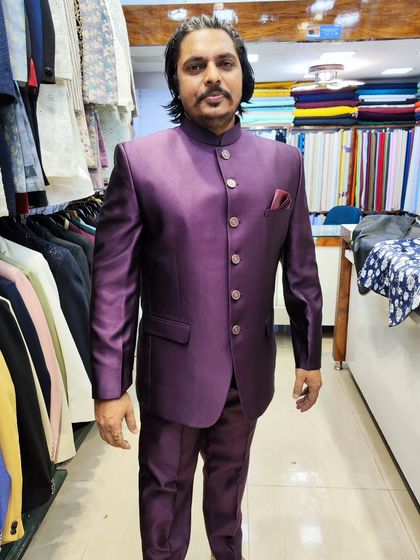 A full-length view of the client in the wine Jodhpuri suit, a perfect example of a classic silhouette in a modern color.