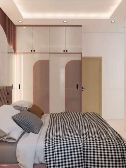 Another angle of the pink bedroom, showing the wardrobe and the overall feminine and chic design.