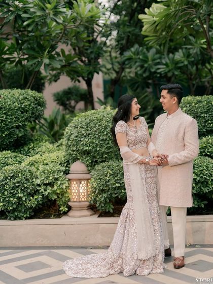 Tushar and Kanupriya sharing a look of love in a lush garden setting during their Roka ceremony.
