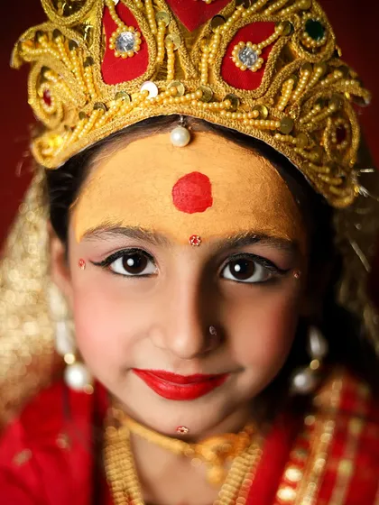 A close-up portrait of my daughter as Maa Durga. The traditional makeup, the bindi, and the crown all come together to create a striking and memorable image.