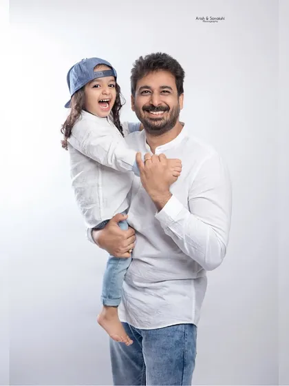 A proud dad with his happy daughter. We love capturing these heartwarming moments during our family studio sessions.