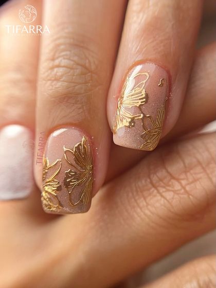 Detailed view of the delicate, hand-drawn golden flowers, showing the fine line work that gives them a lifelike quality.