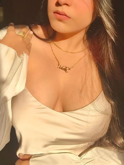 A layered look featuring a custom script name necklace. This image shows how beautifully these personalized pieces can be styled with other jewelry for a unique, curated aesthetic.