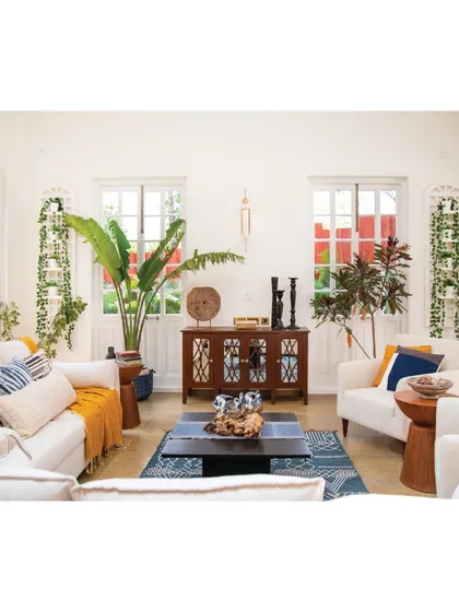 In this tropical villa, the living room is filled with light and greenery. We selected furniture and decor that are relaxed and inviting, with plenty of comfortable seating and natural elements to blur the line between the indoors and the lush Goan landscape outside.