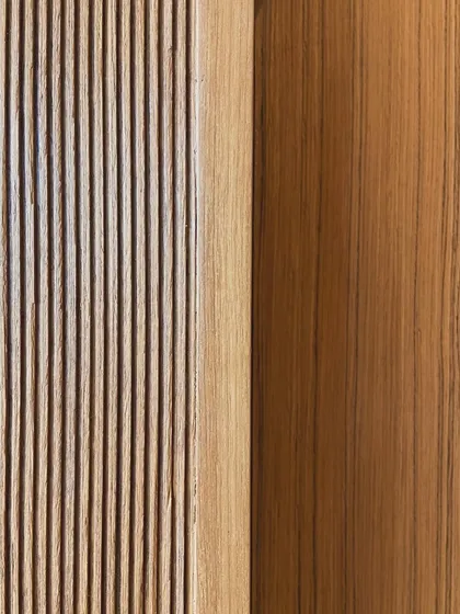 A detail showing the transition from a fluted wood surface to a smooth plane. This careful handling of junctions and transitions is critical to achieving a polished and resolved interior.