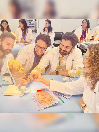 Guiding a group of doctors during the practical session at IMMAS. This kind of interactive learning is invaluable for refining skills.