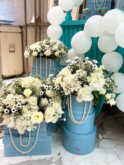 To celebrate a 500k milestone, we designed a surprise "Breakfast at Tiffany's" themed party, using the iconic Tiffany blue, white florals, pearls, and a custom dessert cart.