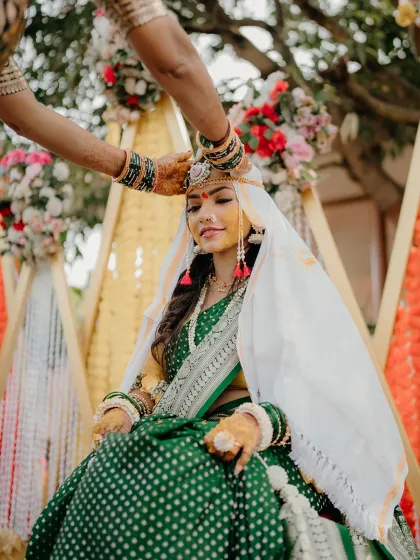 A traditional moment during the Haldi ceremony, where the bride receives blessings from her elders. This photo highlights the cultural significance of the ritual.
