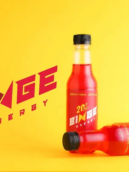 A high-contrast product shot for an energy drink. The bold red and yellow colors are used to create an energetic and graphic composition that aligns with the brand's identity.