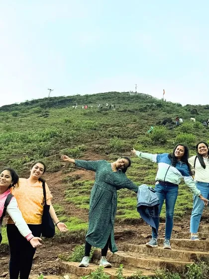 The group having fun on the steps leading up a green hill in Chikmagalur.
