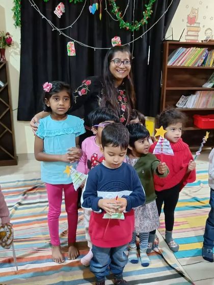 The storyteller and children pose with their Christmas star wands, full of festive cheer.