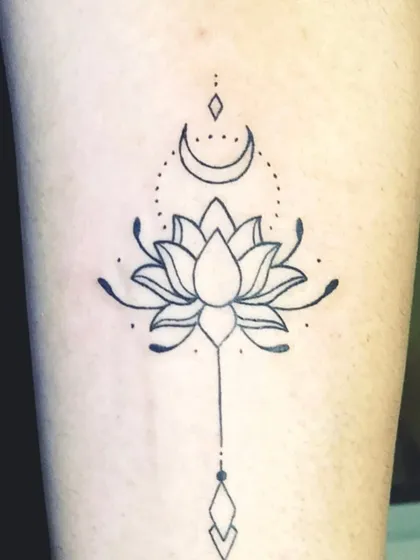 A close-up of the finished lotus and moon tattoo.