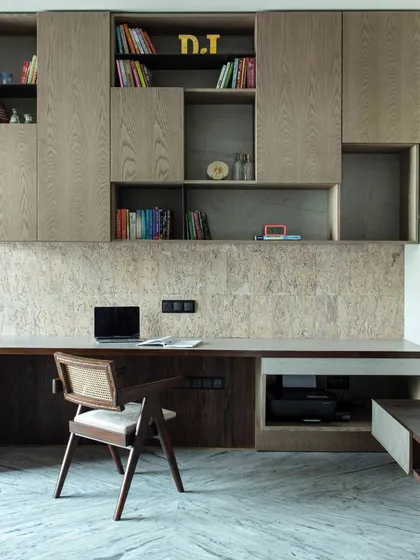 The younger daughter's lounge in our Kolkata project, featuring a custom study unit with ample book storage and a cork-clad wall for displaying art. The space is designed to be both creative and functional.