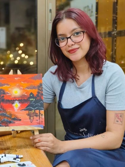 A participant with her beautifully finished sunset painting. Our workshops are a perfect way to unwind, explore your creativity, and connect with other art lovers in the community.