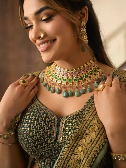 A close-up of the festive glam. The golden-green eyeshadow and perfectly matched jewellery create a look that is both regal and celebratory.