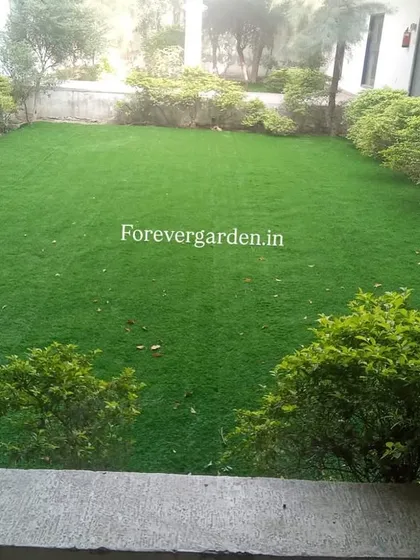 A simple yet elegant solution for a courtyard garden. I installed wall-to-wall artificial turf surrounded by natural shrubs, creating a perfect, maintenance-free lawn.