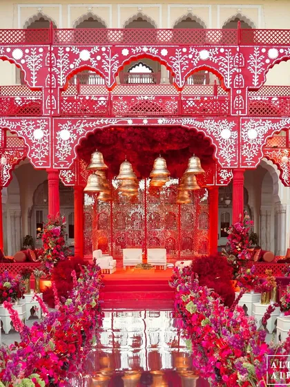 For a couple deeply rooted in tradition, I designed this 'Kaanch Bagh' mandap, a modern Sheesh Mahal adorned in a powerful, passionate red. The design honors royal Indian architecture with thousands of mirror pieces and kinetic bells, creating a sacred and mesmerizing space.