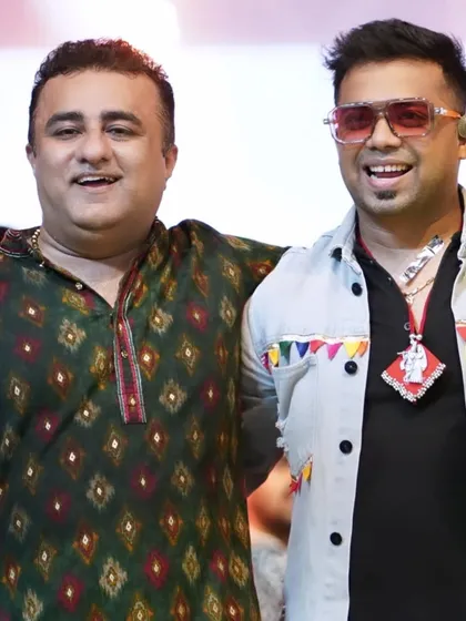Posing with a talented singer and friend at a Navratri event. I have built strong relationships within the entertainment industry.