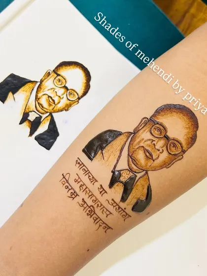 My finished Dr. Babasaheb Ambedkar portrait next to a practice version. Practice is key to perfecting the fine details in portraiture.