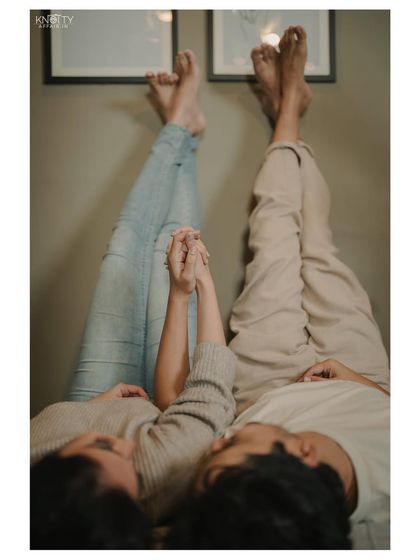 A creative and cute shot focusing on the couple's connection, symbolized by their held hands. It's a simple, artistic way to capture their bond.