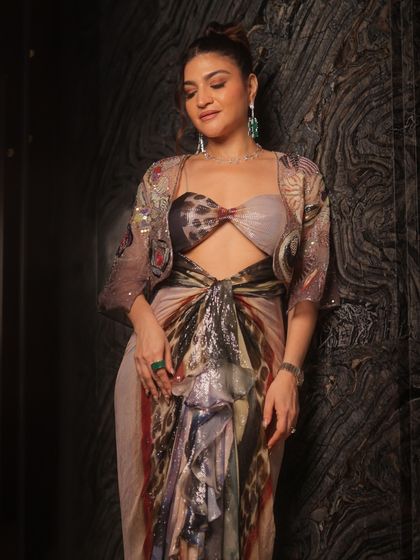 Another angle of this stunning look, showing how the makeup complements the intricate patterns and colors of her outfit.