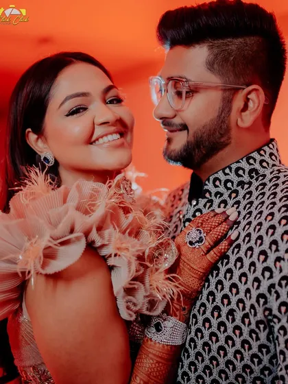 Saloni and Vatsal share a happy, loving glance during their sangeet. Her unique ruffled outfit and his patterned jacket show off their amazing style.
