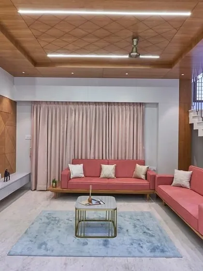 A closer look at the living area, showing the textured wood paneling on the TV wall and the patterned ceiling detail. These elements add layers of visual interest and a sense of bespoke craftsmanship.