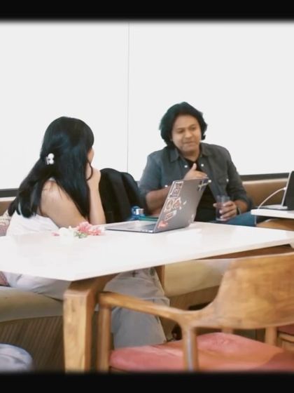 A candid shot of two people in a work discussion, showing how our space facilitates collaboration and connection.