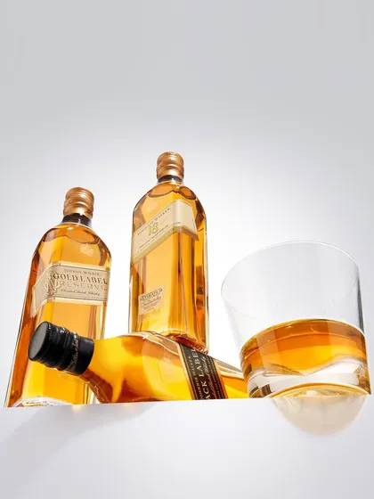 Behold the liquid gold. This shot of Johnnie Walker bottles was about creating a pristine, high-end feel. The clean white background makes the golden color of the whiskey the absolute hero of the image.