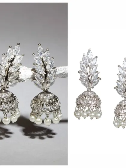 Can you believe these are just 6 grams? These silver-toned jhumkas are embedded with sparkling stones and finished with pearls, offering a touch of glamour in a very lightweight design.