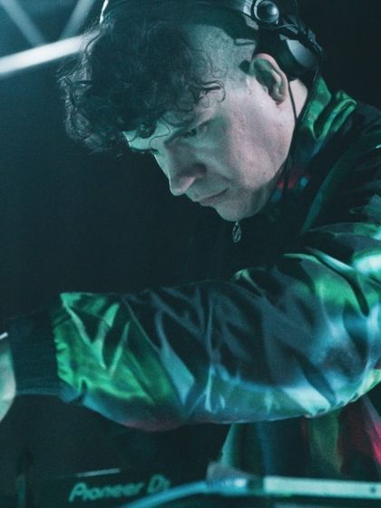 The DJ for "To Da Bone" focused on his console. Music is a driving force in this high-energy dance performance, blending hardstyle and electronic beats.