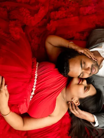 Couple portraits are about capturing your connection before the new arrival. This top-down shot in a vibrant red gown creates an intimate and visually striking memory for you and your partner.
