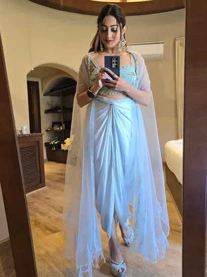 A trendy dhoti-style outfit in pastel blue. I like to stay on top of the latest fashion trends and incorporate them into my hosting wardrobe.