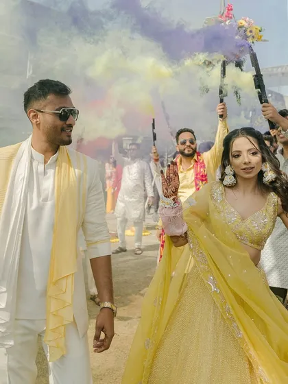 A grand entry with colorful smoke bombs, creating a stunning visual for the couple's arrival.