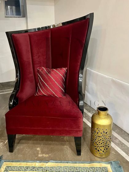 A dramatic, high-back 'throne' chair in deep red velvet with a glossy black lacquered wood frame. This is a true showstopper piece, designed to be the focal point of any room.