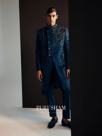 Transcend to a world of boundless brilliance. The details on this deep teal jacket, with its asymmetrical embroidery, are designed to capture and hold attention.