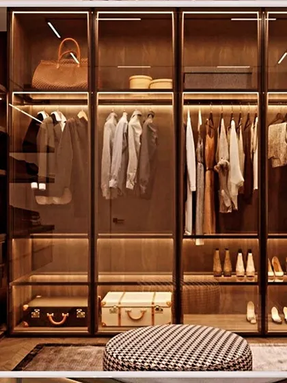 This is what a dream walk-in closet looks like. We used profile glass shutters to create a boutique-like display, while warm interior lighting highlights the collection and makes finding the perfect outfit effortless.