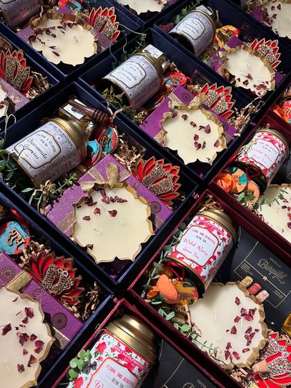 Another angle of our assorted Diwali hampers. The mix of purple and red-themed boxes shows the variety we can offer for a single client's needs.