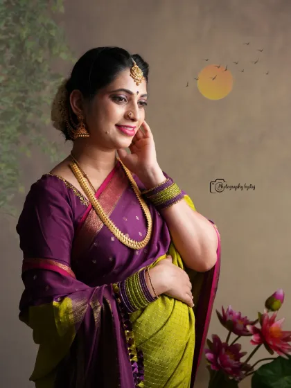 An artistic studio portrait of a mother-to-be in a traditional saree, with a serene expression and beautiful lighting.