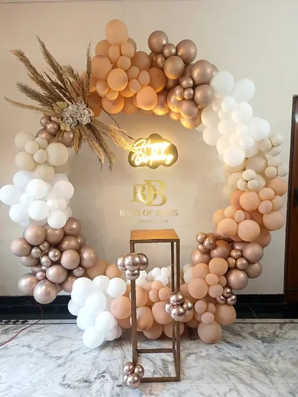 A beautiful boho-themed birthday ring backdrop. This full circle is adorned with neutral-toned balloons in cream and rose gold, accented with pampas grass for a soft, rustic, and elegant look.
