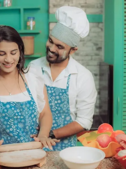 Love is cooking up something beautiful! This couple shares a laugh in a quirky kitchen setting, a perfect example of a themed pre-wedding shoot that reflects shared interests and creates fun, natural interactions.