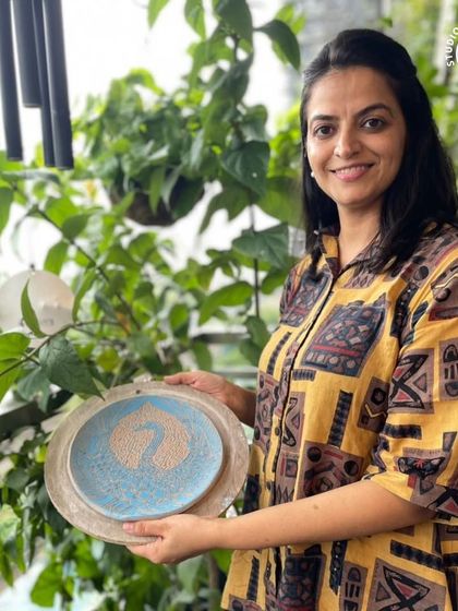 This student created a lovely swan design on her plate using the Sgraffito carving technique.
